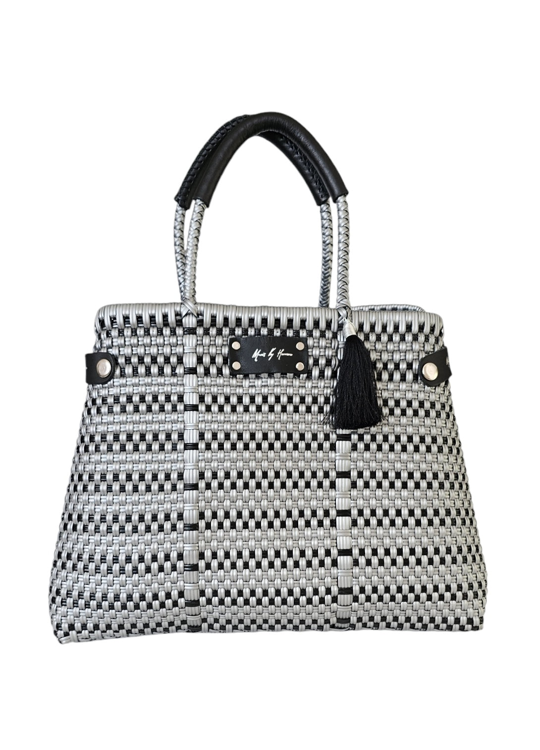 Handcrafted silver and black handbag made from recycled plastic and leather, with a convertible tote design