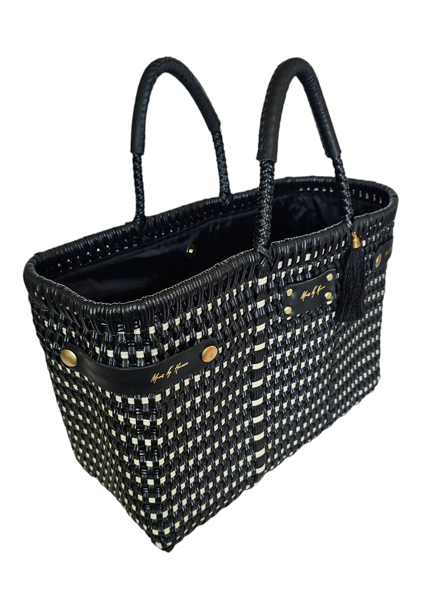 Luxury handwoven handbag that transforms into a tote bag for added versatility in color black with leather handles.