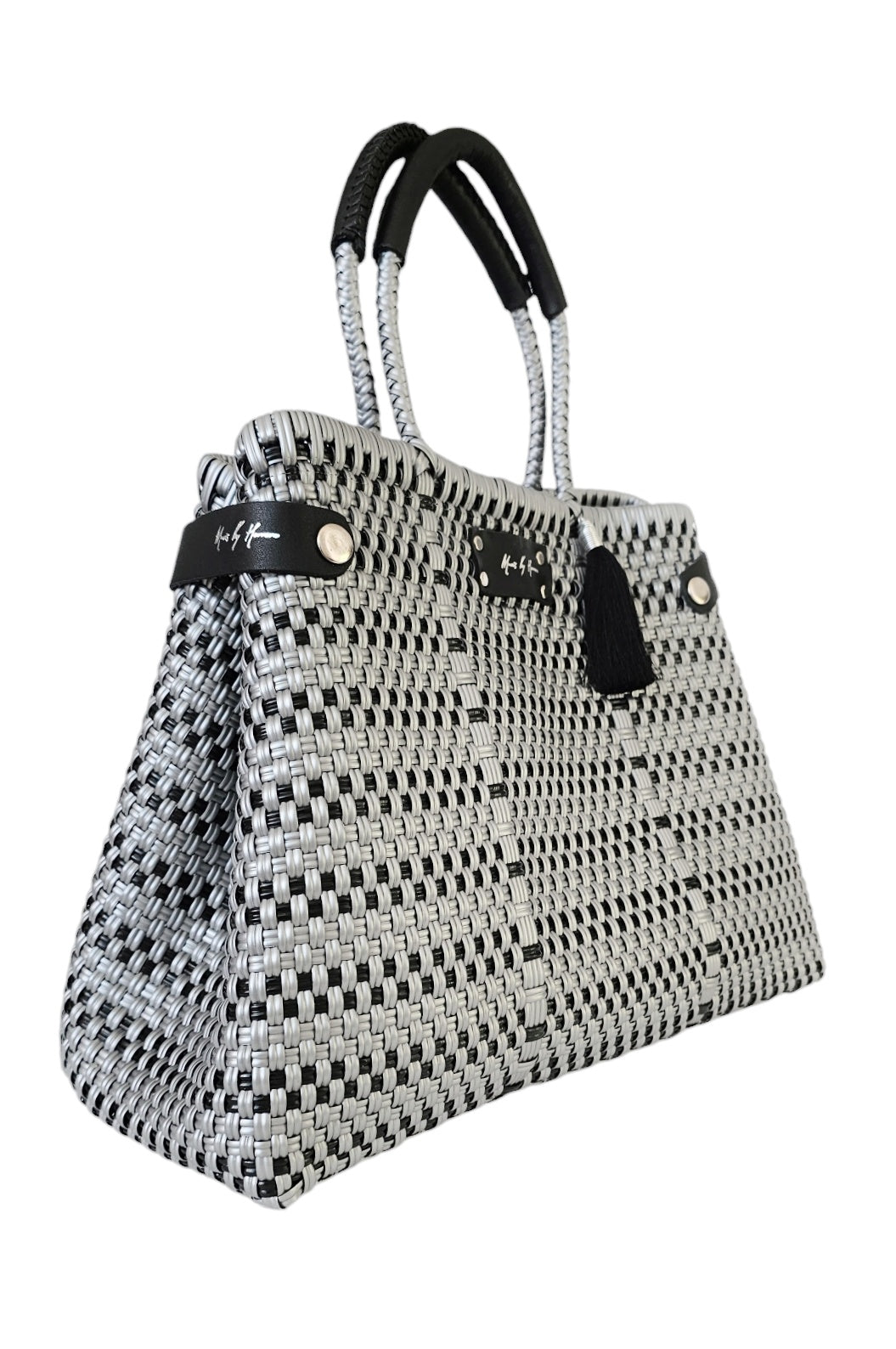 Handcrafted silver and black handbag made from recycled plastic and leather, with a convertible tote design.